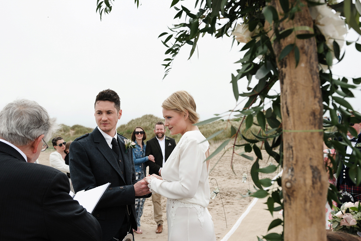 Laura wears a 1970's inspired Stone Cold Fox wedding dress for her laid back and organic beach wedding in Scotland. Photography by Tino and Pip.