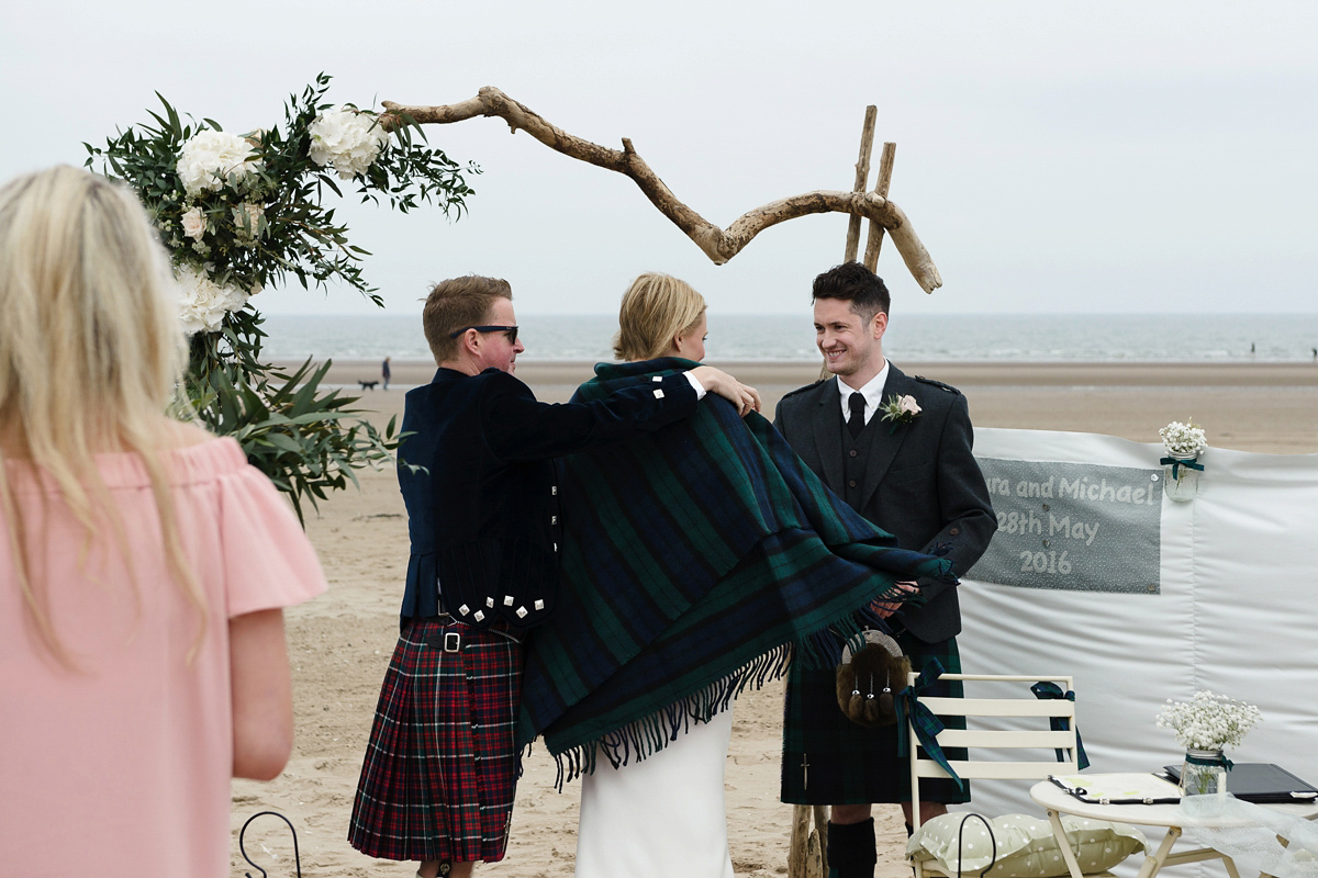 Laura wears a 1970's inspired Stone Cold Fox wedding dress for her laid back and organic beach wedding in Scotland. Photography by Tino and Pip.