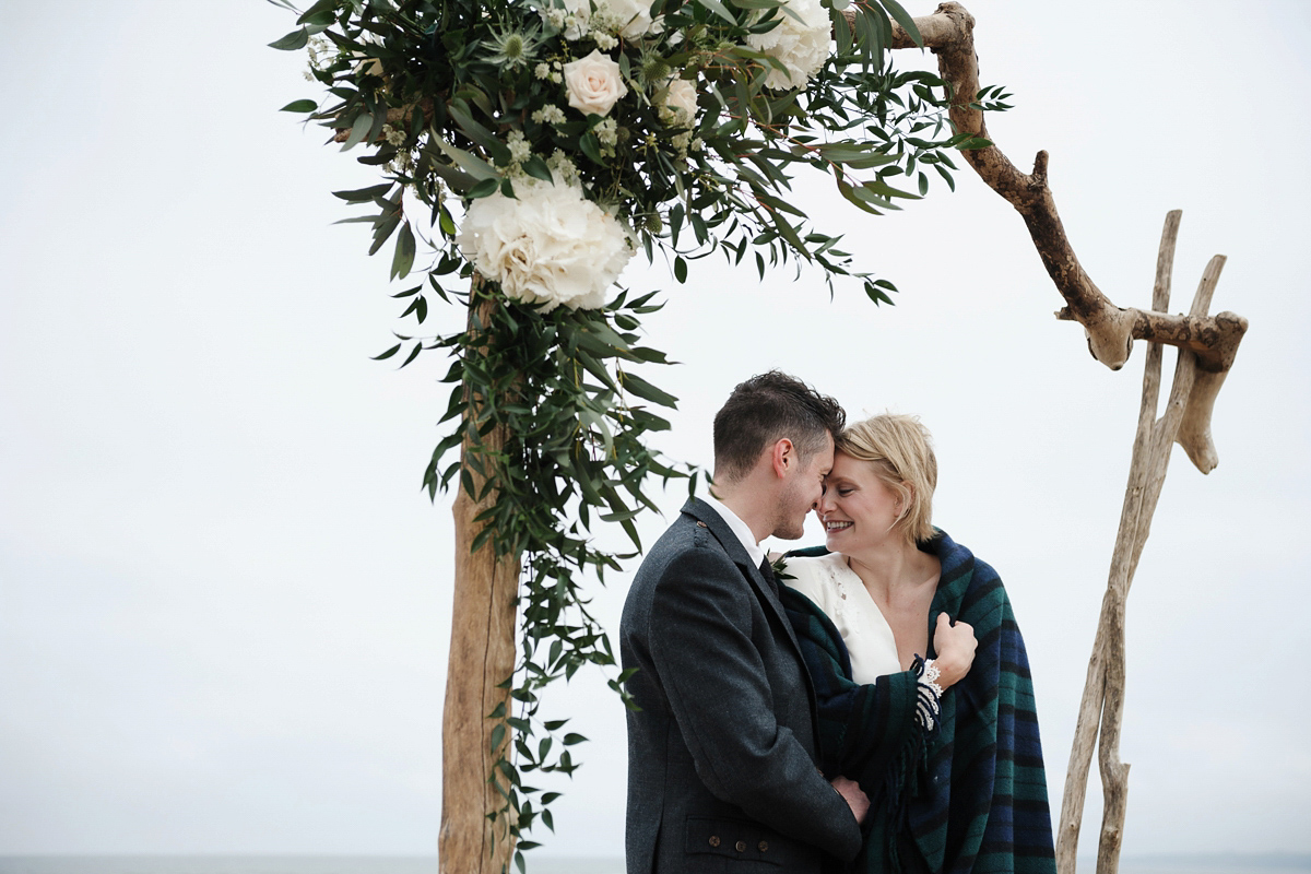 Laura wears a 1970's inspired Stone Cold Fox wedding dress for her laid back and organic beach wedding in Scotland. Photography by Tino and Pip.