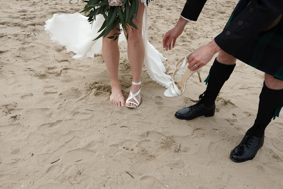 Laura wears a 1970's inspired Stone Cold Fox wedding dress for her laid back and organic beach wedding in Scotland. Photography by Tino and Pip.