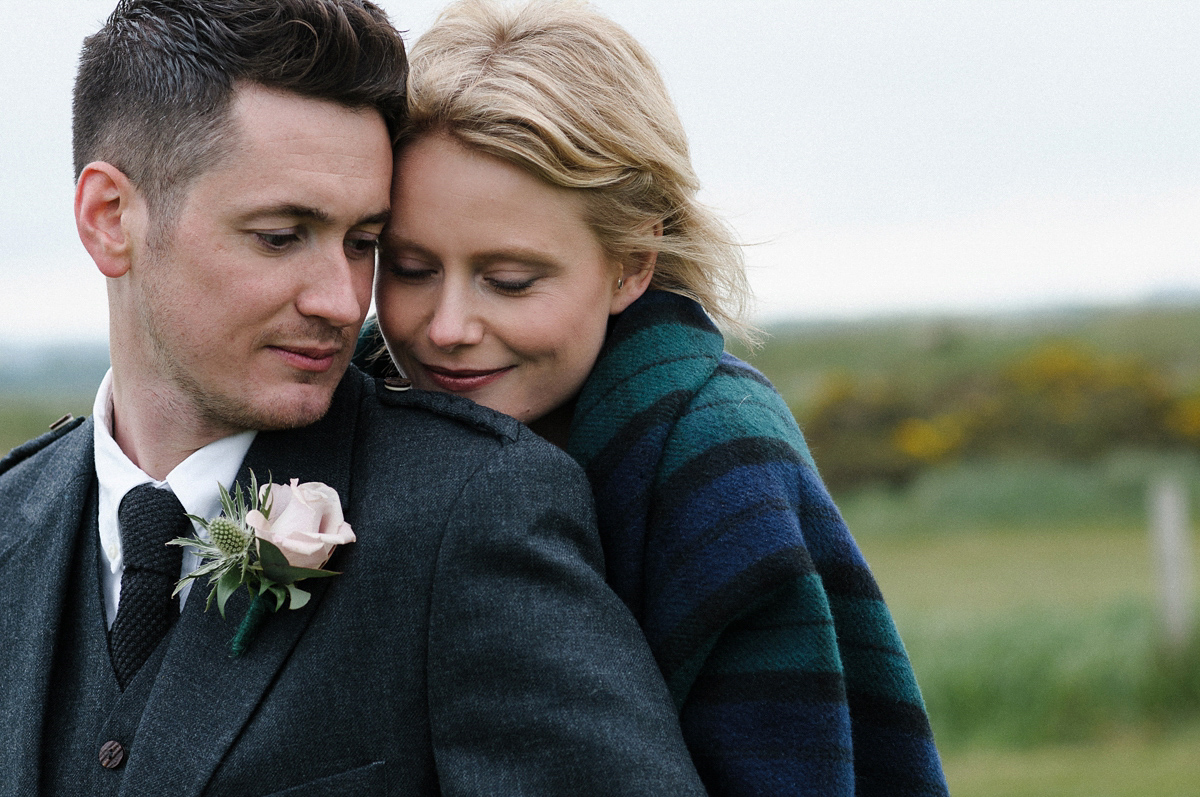 Laura wears a 1970's inspired Stone Cold Fox wedding dress for her laid back and organic beach wedding in Scotland. Photography by Tino and Pip.