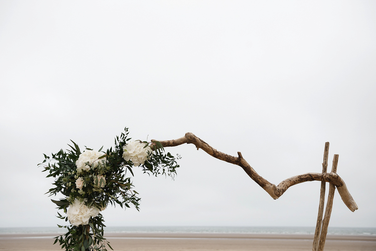 Laura wears a 1970's inspired Stone Cold Fox wedding dress for her laid back and organic beach wedding in Scotland. Photography by Tino and Pip.
