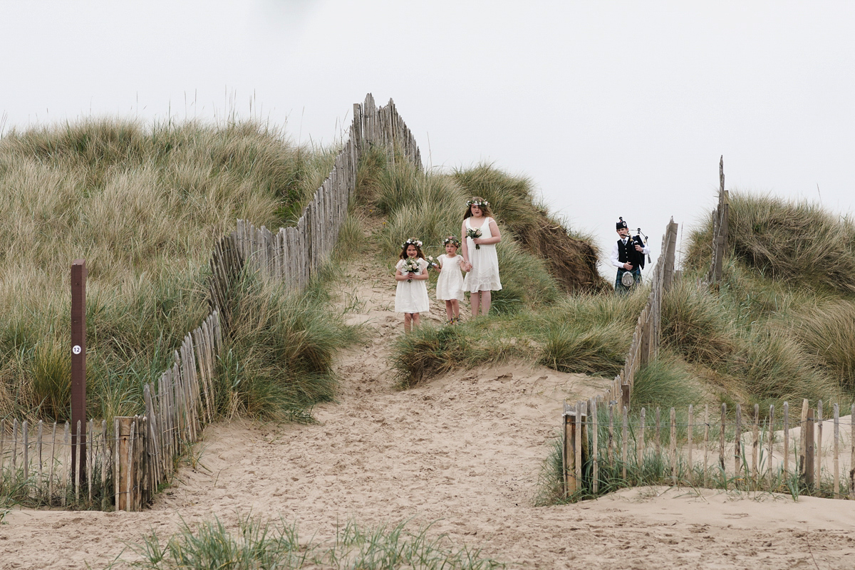 Laura wears a 1970's inspired Stone Cold Fox wedding dress for her laid back and organic beach wedding in Scotland. Photography by Tino and Pip.