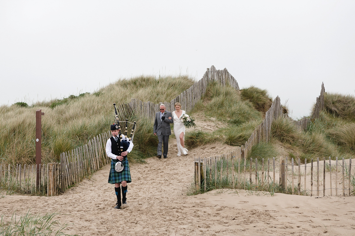 Laura wears a 1970's inspired Stone Cold Fox wedding dress for her laid back and organic beach wedding in Scotland. Photography by Tino and Pip.