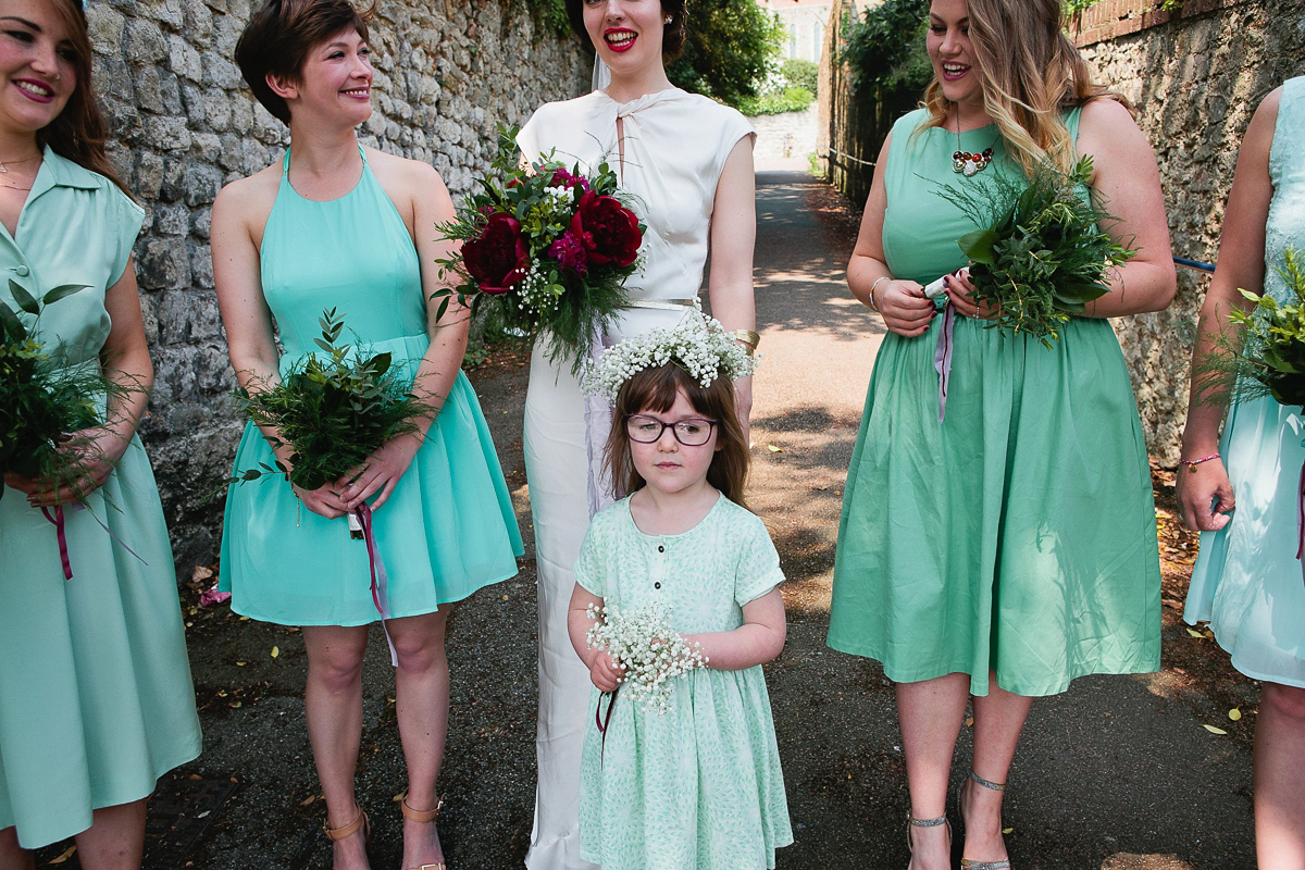 Sophie wore a Ghost dress for her elegant Spring wedding. Her bridesmaids wore mint green. Photography by Matilda Delves.