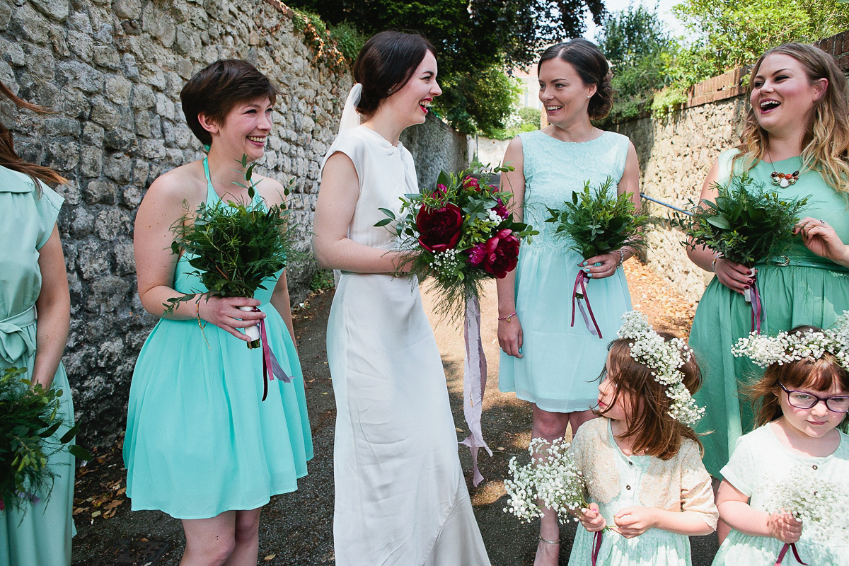 Sophie wore a Ghost dress for her elegant Spring wedding. Her bridesmaids wore mint green. Photography by Matilda Delves.