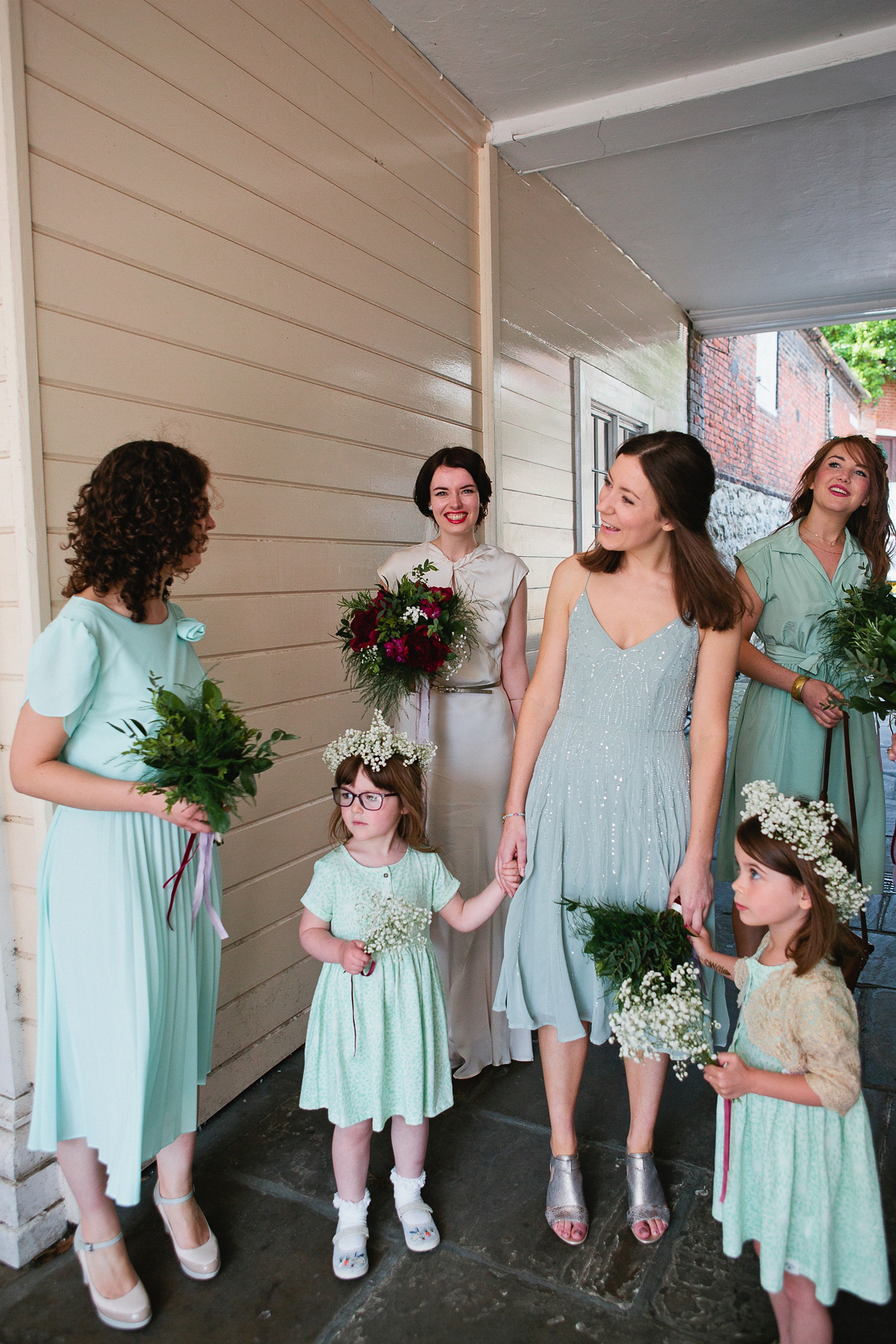 Sophie wore a Ghost dress for her elegant Spring wedding. Her bridesmaids wore mint green. Photography by Matilda Delves.