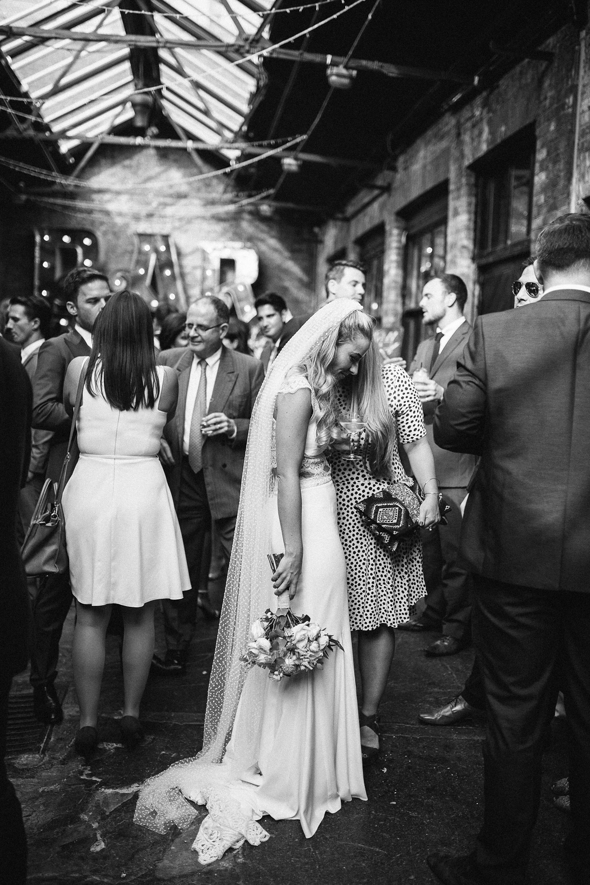 Emma wore Rime Aradaky separates and a polka dot veil by Luna Bea, for her fun, relaxed and cool East London wedding at MC Motors in Dalston. Photography by Emma & Pete.