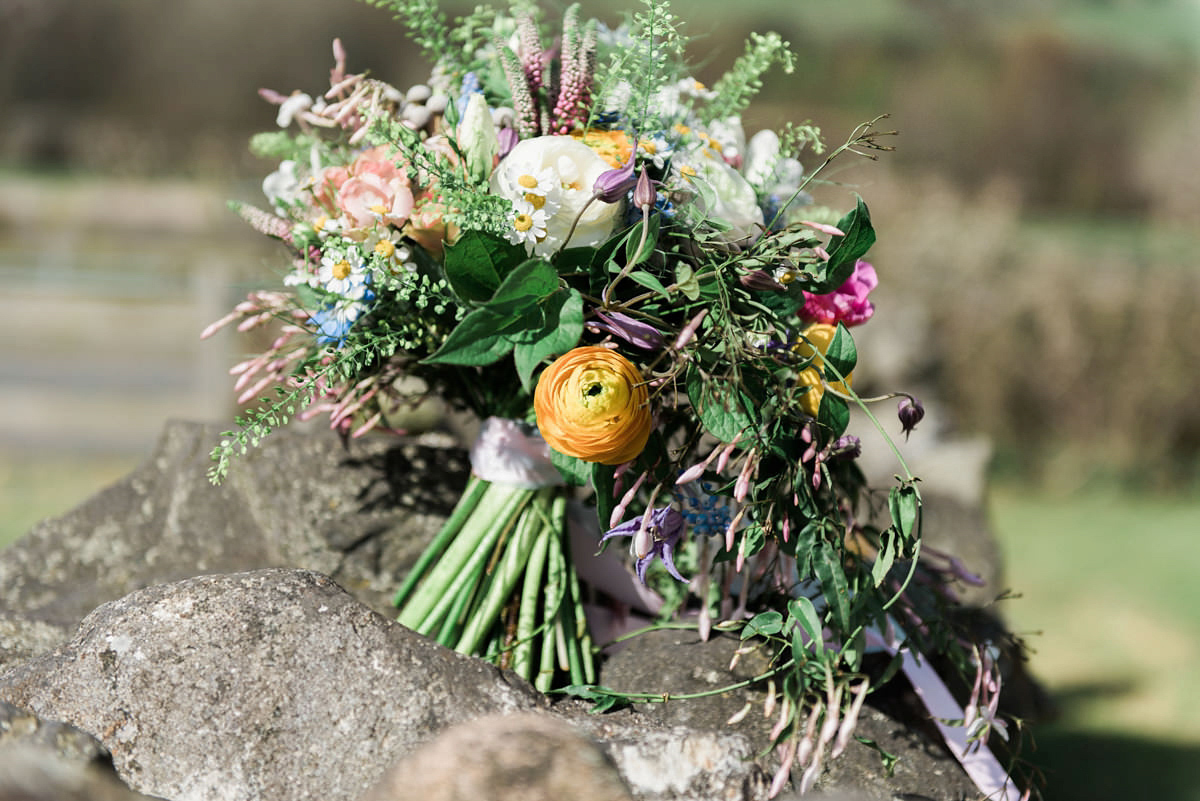 Suzi wears a Yolancris dress and flower crown for her rustic, intimate wedding in the Lake District. Photography by Sarah Folega.