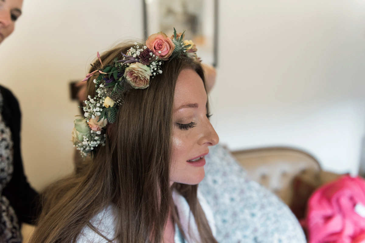 Suzi wears a Yolancris dress and flower crown for her rustic, intimate wedding in the Lake District. Photography by Sarah Folega.