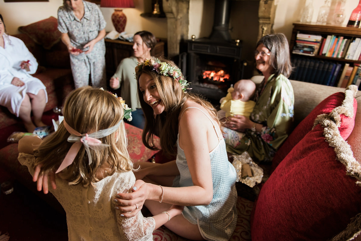 Suzi wears a Yolancris dress and flower crown for her rustic, intimate wedding in the Lake District. Photography by Sarah Folega.