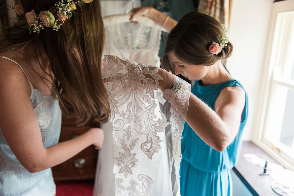 Suzi wears a Yolancris dress and flower crown for her rustic, intimate wedding in the Lake District. Photography by Sarah Folega.
