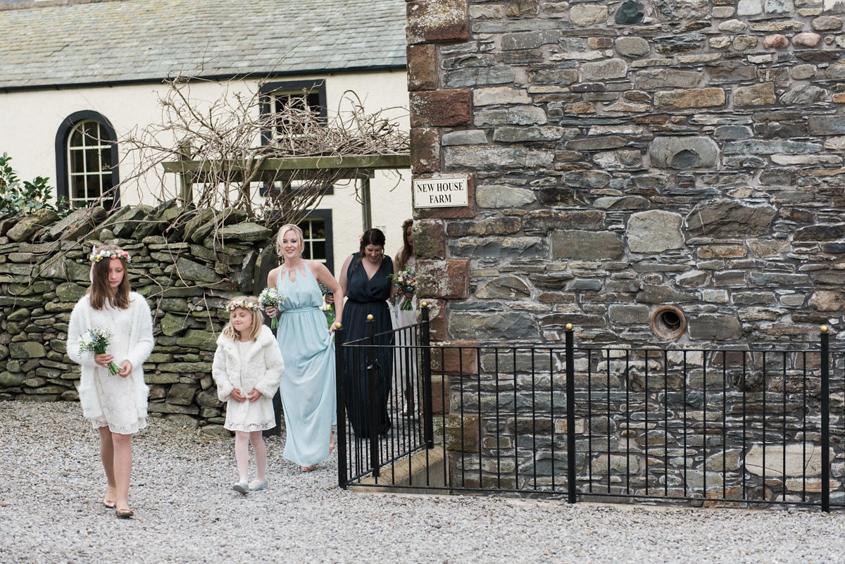 Suzi wears a Yolancris dress and flower crown for her rustic, intimate wedding in the Lake District. Photography by Sarah Folega.