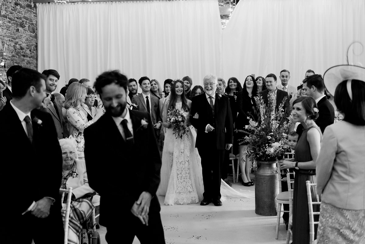 Suzi wears a Yolancris dress and flower crown for her rustic, intimate wedding in the Lake District. Photography by Sarah Folega.