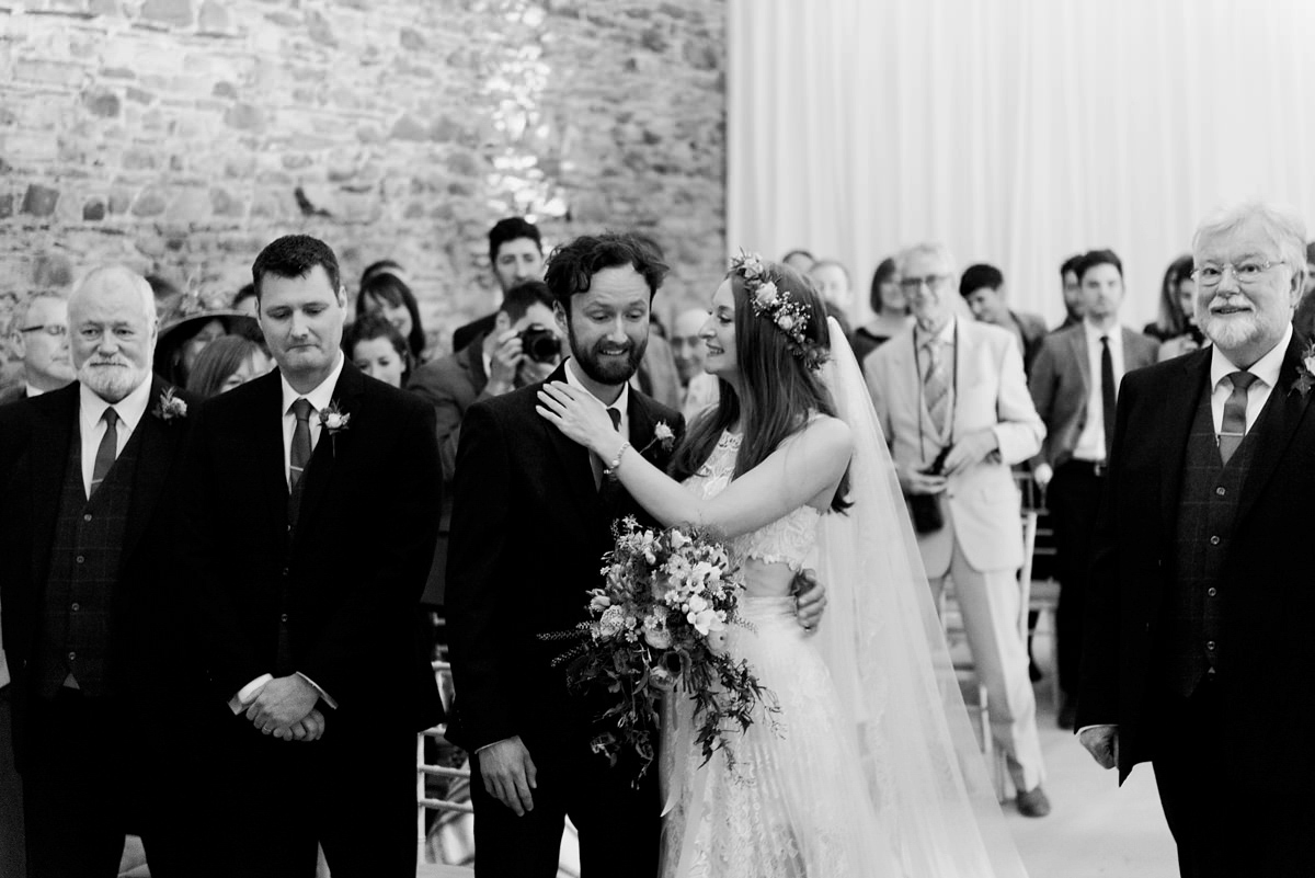 Suzi wears a Yolancris dress and flower crown for her rustic, intimate wedding in the Lake District. Photography by Sarah Folega.