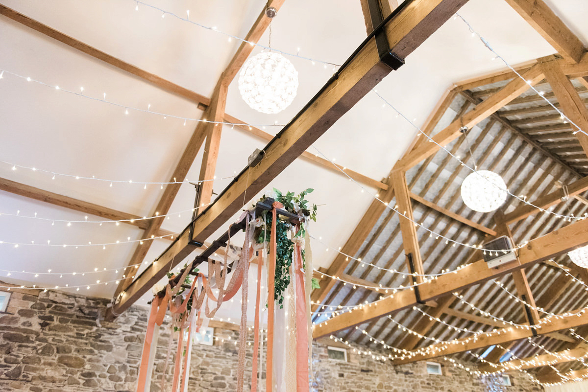 Suzi wears a Yolancris dress and flower crown for her rustic, intimate wedding in the Lake District. Photography by Sarah Folega.