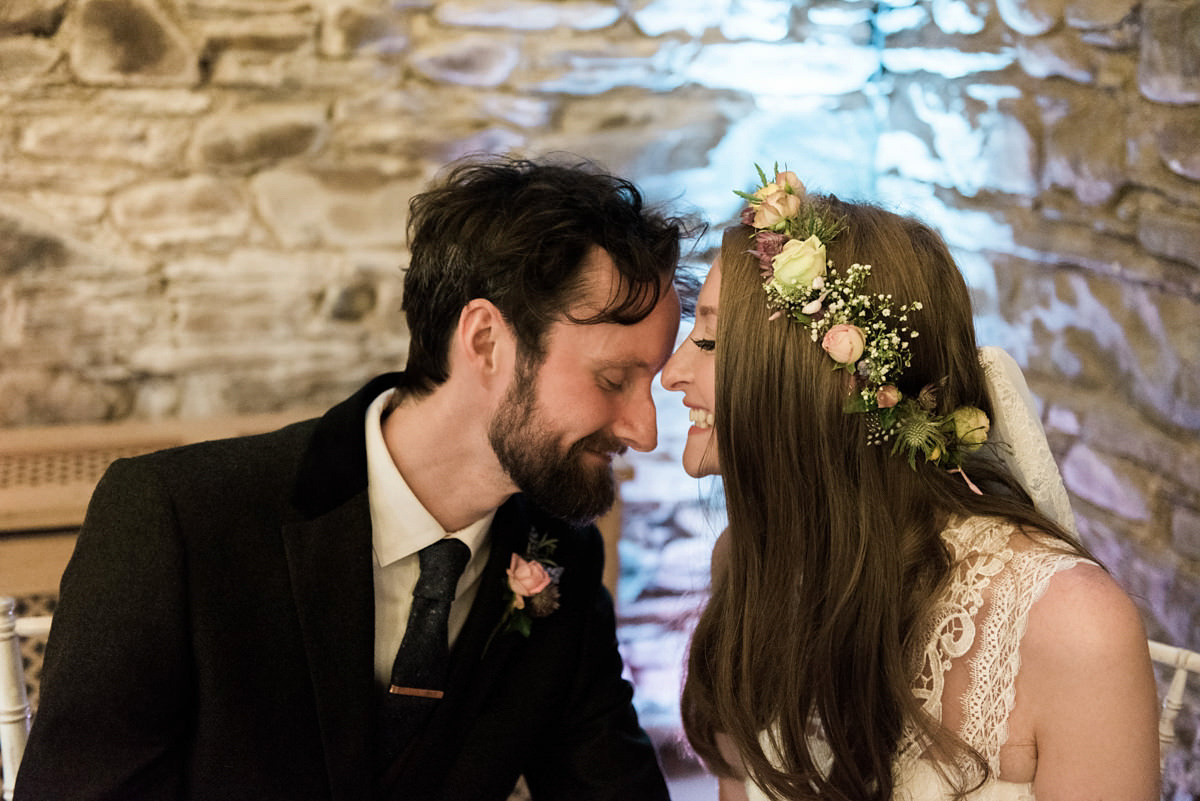 Suzi wears a Yolancris dress and flower crown for her rustic, intimate wedding in the Lake District. Photography by Sarah Folega.