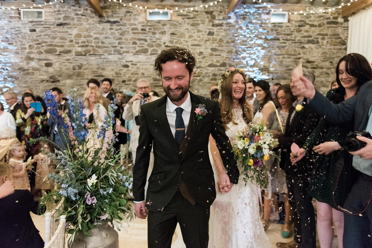 Suzi wears a Yolancris dress and flower crown for her rustic, intimate wedding in the Lake District. Photography by Sarah Folega.