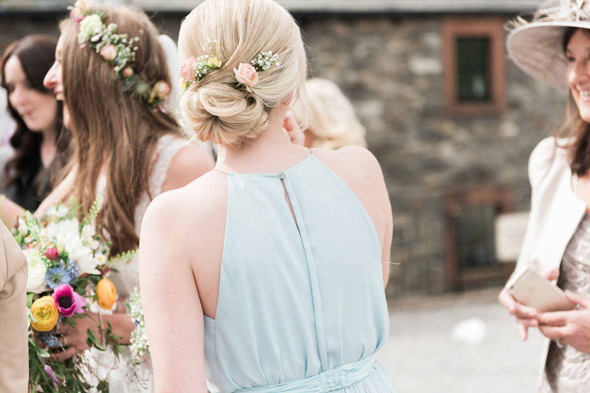 Suzi wears a Yolancris dress and flower crown for her rustic, intimate wedding in the Lake District. Photography by Sarah Folega.