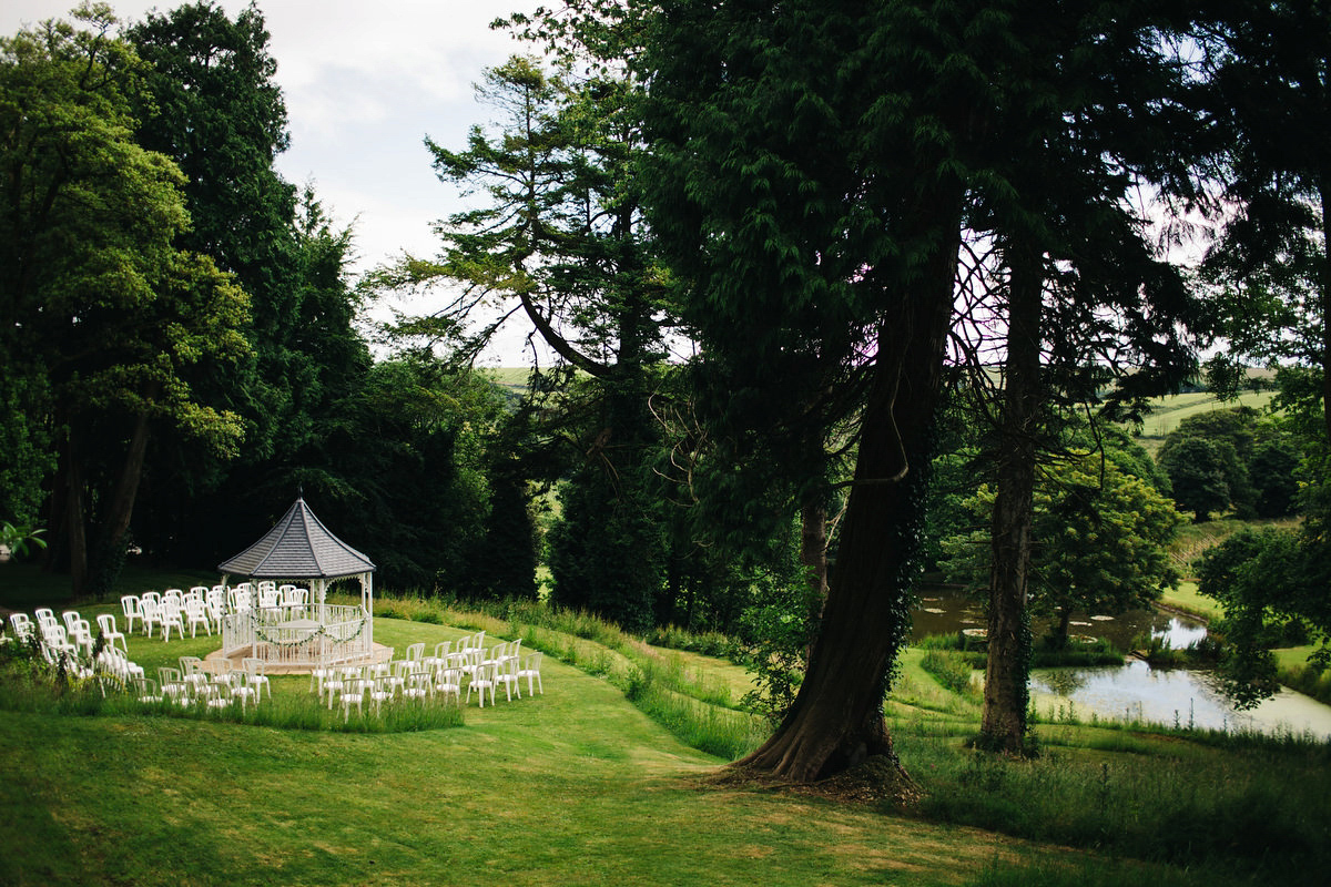 Boho bride Alice wore a pale green lace wedding dress and floral crown for her wild woodland inspired, free spirited South Devon wedding at Langdon Court. Photography by Richard Skins.