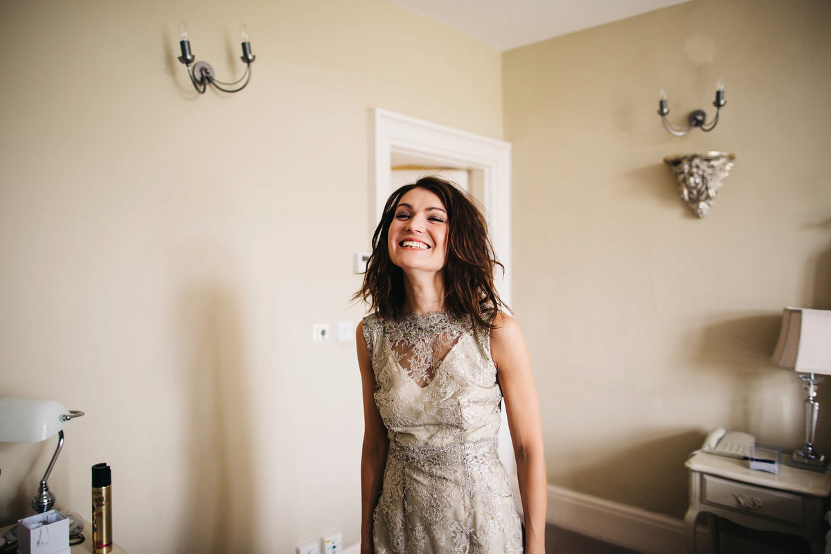 Boho bride Alice wore a pale green lace wedding dress and floral crown for her wild woodland inspired, free spirited South Devon wedding at Langdon Court. Photography by Richard Skins.