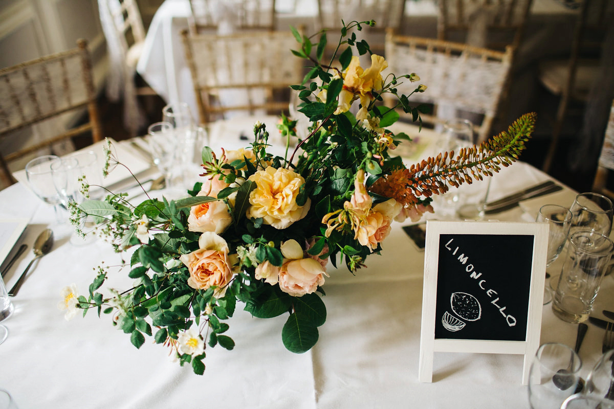 Boho bride Alice wore a pale green lace wedding dress and floral crown for her wild woodland inspired, free spirited South Devon wedding at Langdon Court. Photography by Richard Skins.