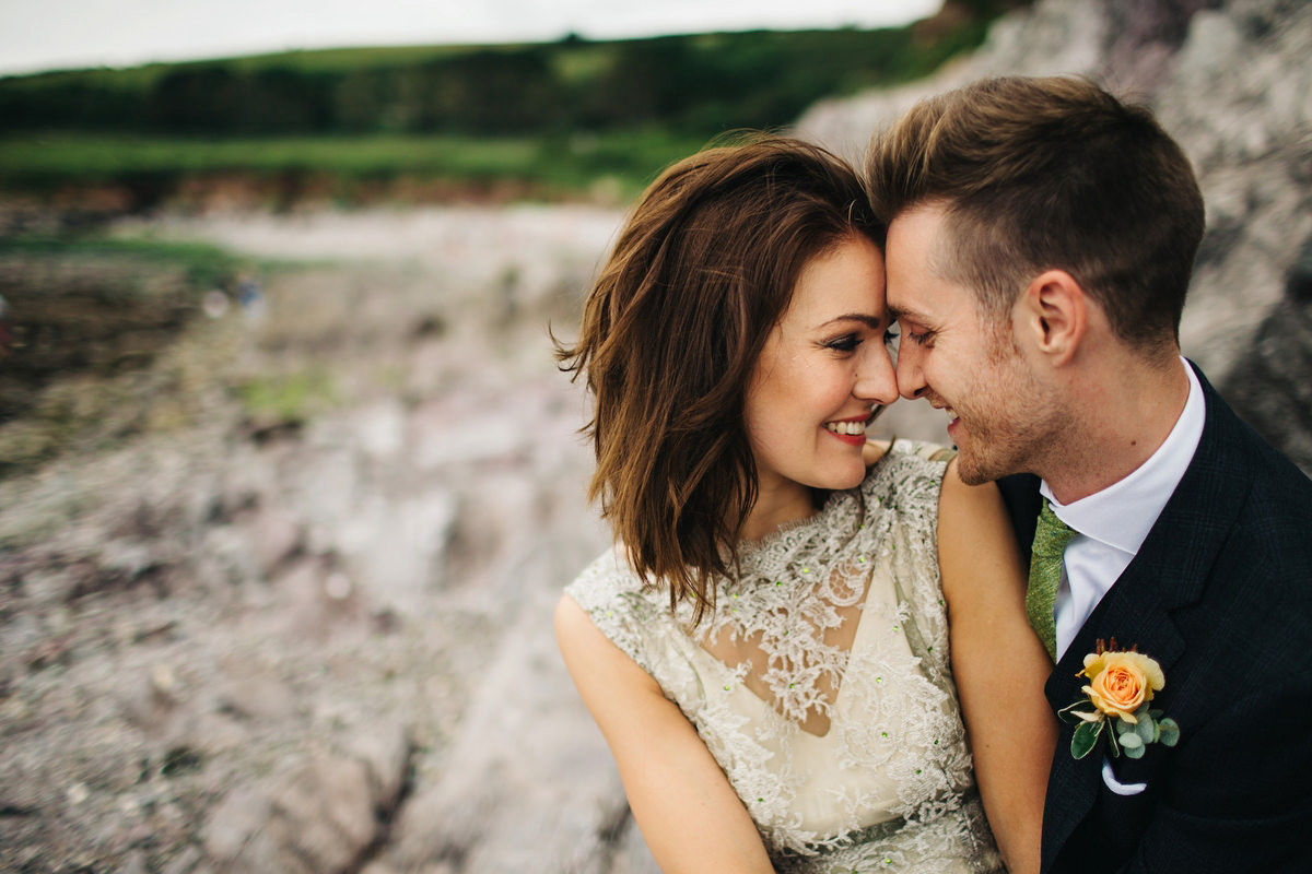 Boho bride Alice wore a pale green lace wedding dress and floral crown for her wild woodland inspired, free spirited South Devon wedding at Langdon Court. Photography by Richard Skins.