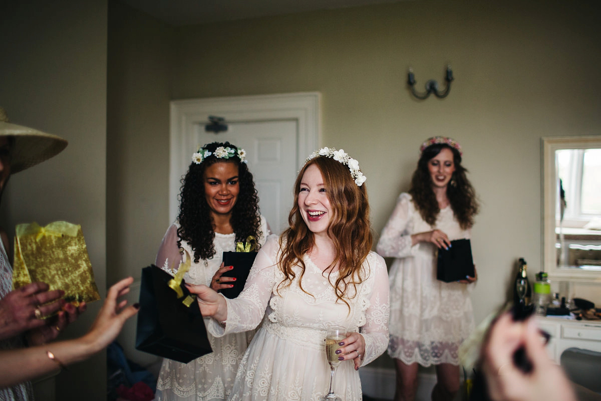 Boho bride Alice wore a pale green lace wedding dress and floral crown for her wild woodland inspired, free spirited South Devon wedding at Langdon Court. Photography by Richard Skins.