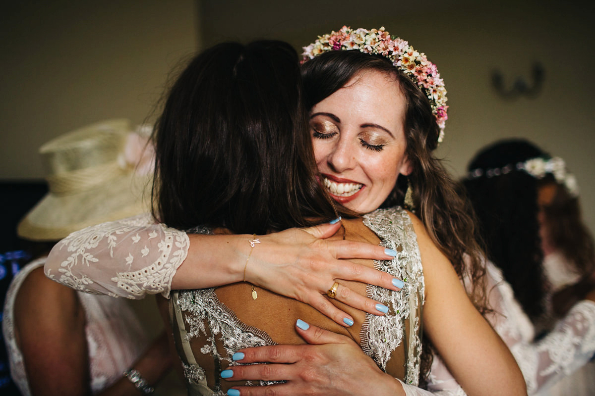 Boho bride Alice wore a pale green lace wedding dress and floral crown for her wild woodland inspired, free spirited South Devon wedding at Langdon Court. Photography by Richard Skins.