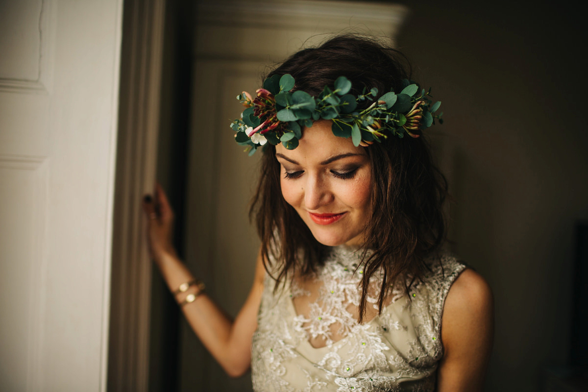 Boho bride Alice wore a pale green lace wedding dress and floral crown for her wild woodland inspired, free spirited South Devon wedding at Langdon Court. Photography by Richard Skins.