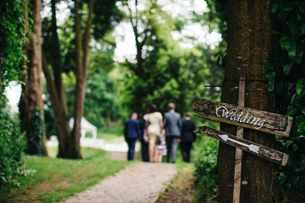 Boho bride Alice wore a pale green lace wedding dress and floral crown for her wild woodland inspired, free spirited South Devon wedding at Langdon Court. Photography by Richard Skins.