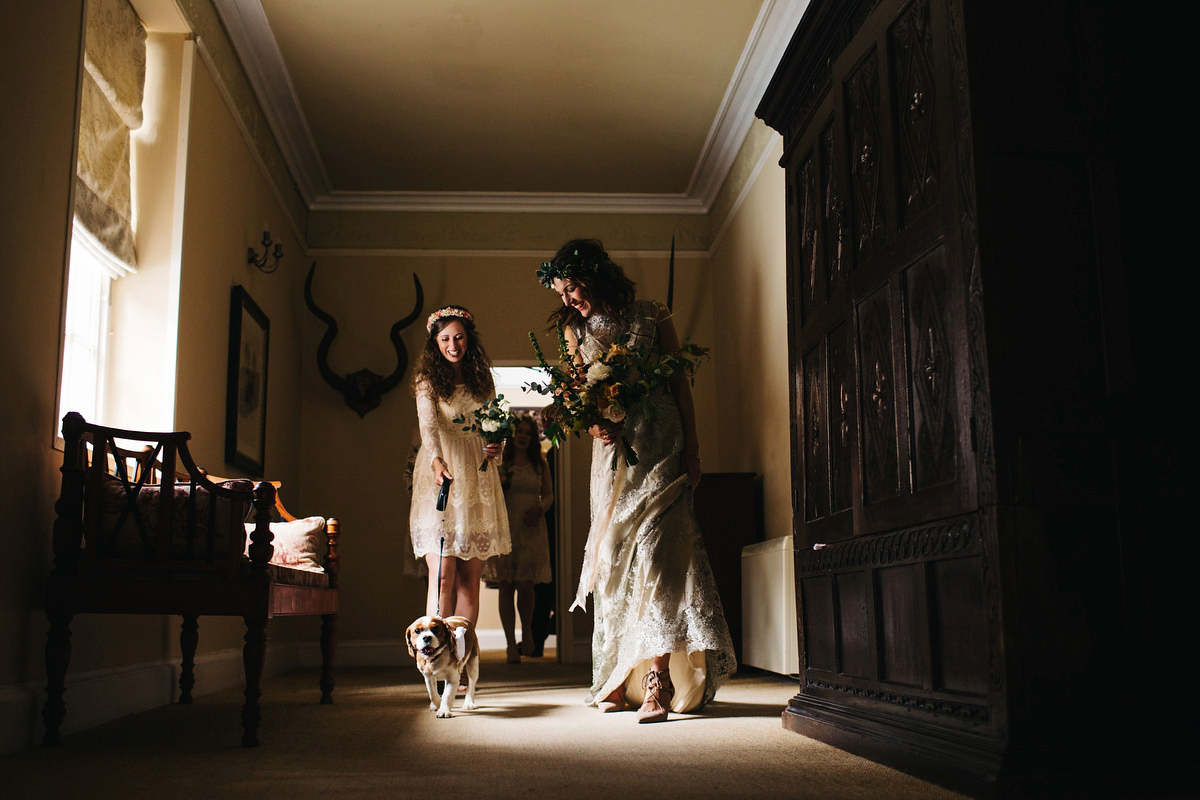 Boho bride Alice wore a pale green lace wedding dress and floral crown for her wild woodland inspired, free spirited South Devon wedding at Langdon Court. Photography by Richard Skins.