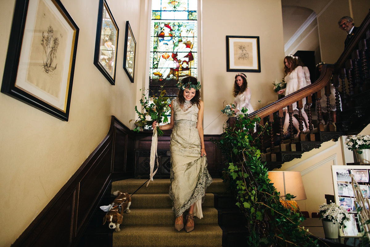 Boho bride Alice wore a pale green lace wedding dress and floral crown for her wild woodland inspired, free spirited South Devon wedding at Langdon Court. Photography by Richard Skins.