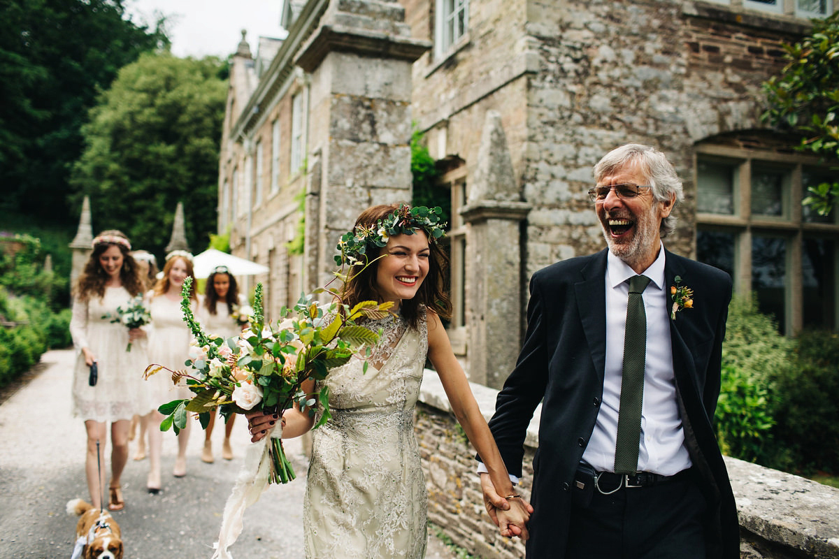 Boho bride Alice wore a pale green lace wedding dress and floral crown for her wild woodland inspired, free spirited South Devon wedding at Langdon Court. Photography by Richard Skins.