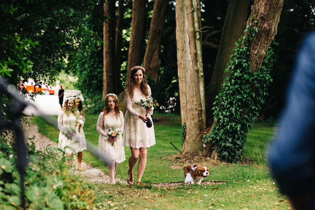 Boho bride Alice wore a pale green lace wedding dress and floral crown for her wild woodland inspired, free spirited South Devon wedding at Langdon Court. Photography by Richard Skins.