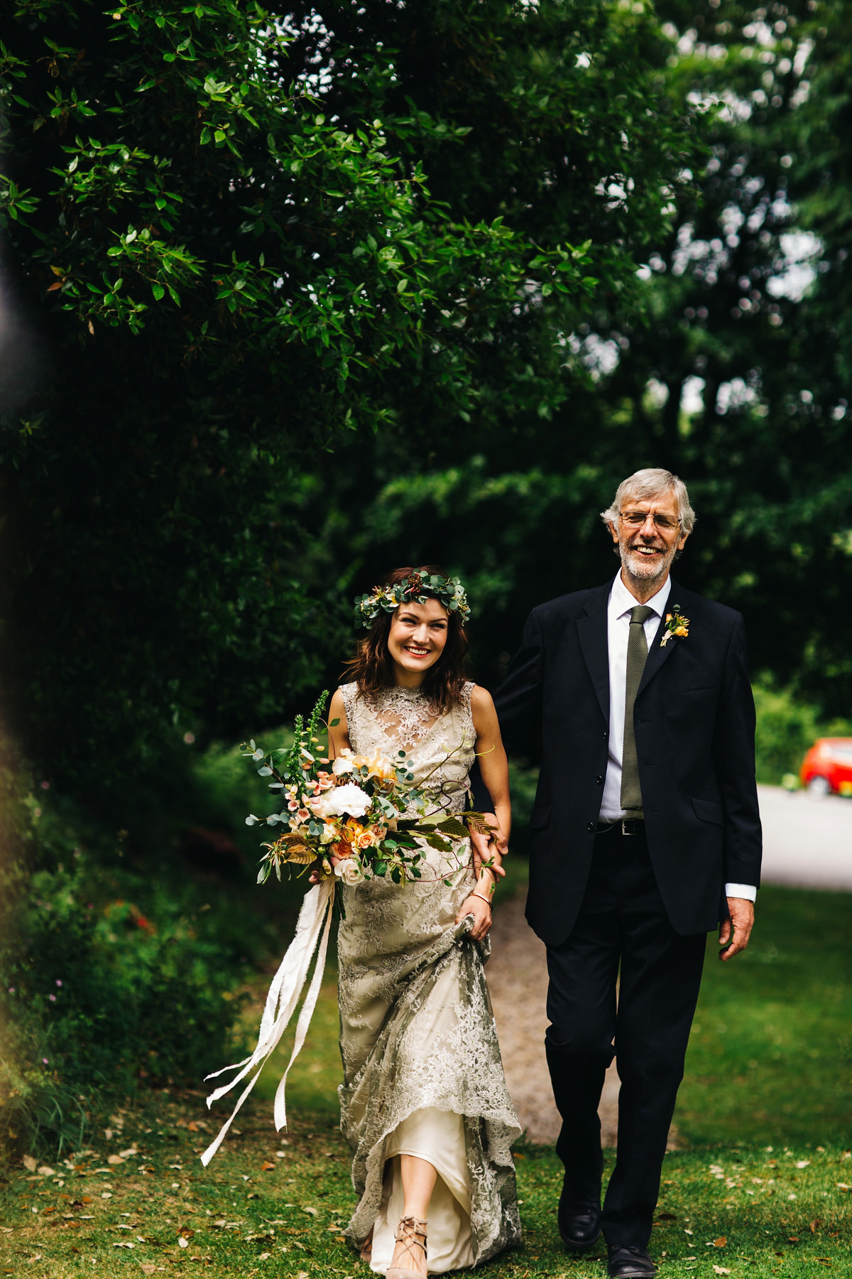 Boho bride Alice wore a pale green lace wedding dress and floral crown for her wild woodland inspired, free spirited South Devon wedding at Langdon Court. Photography by Richard Skins.