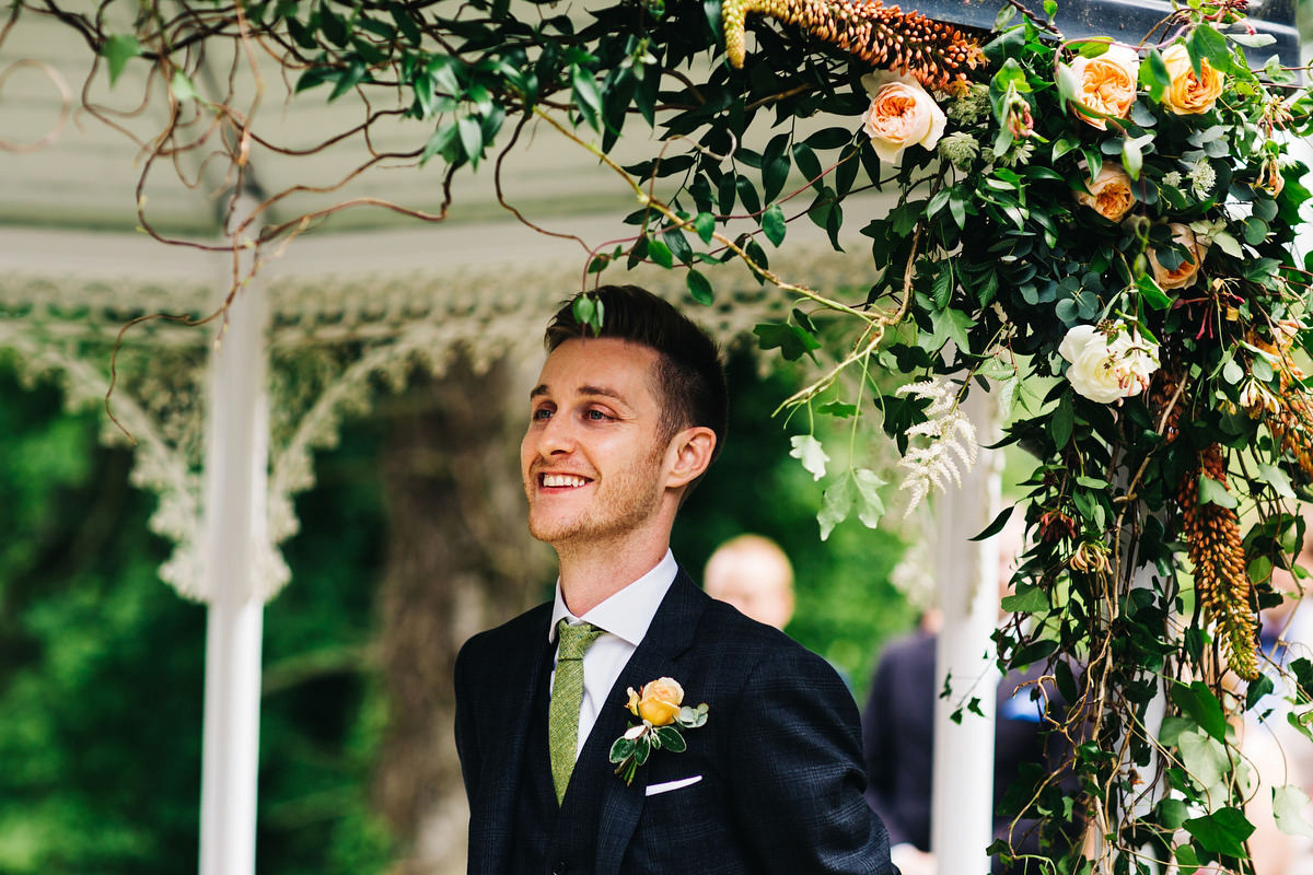 Boho bride Alice wore a pale green lace wedding dress and floral crown for her wild woodland inspired, free spirited South Devon wedding at Langdon Court. Photography by Richard Skins.