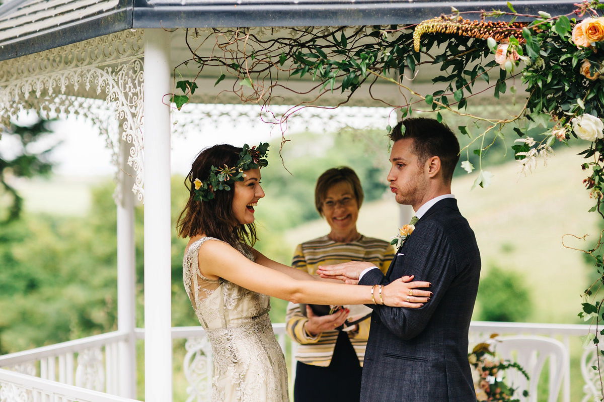 Boho bride Alice wore a pale green lace wedding dress and floral crown for her wild woodland inspired, free spirited South Devon wedding at Langdon Court. Photography by Richard Skins.