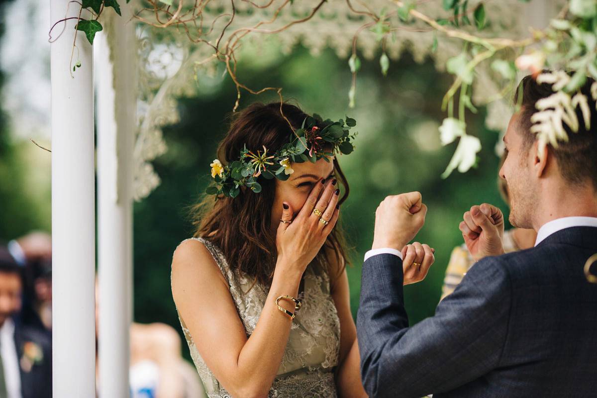 Boho bride Alice wore a pale green lace wedding dress and floral crown for her wild woodland inspired, free spirited South Devon wedding at Langdon Court. Photography by Richard Skins.