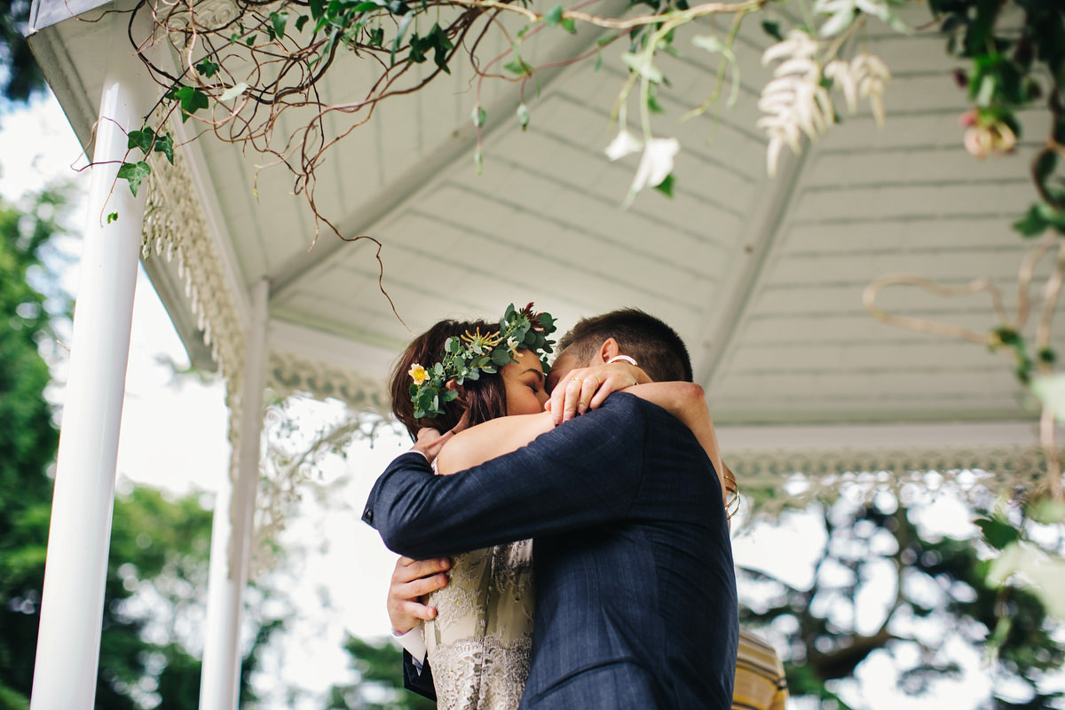 Boho bride Alice wore a pale green lace wedding dress and floral crown for her wild woodland inspired, free spirited South Devon wedding at Langdon Court. Photography by Richard Skins.