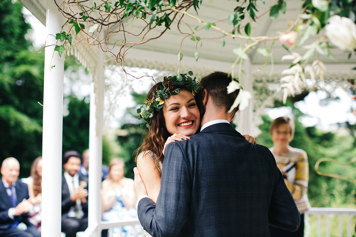 Boho bride Alice wore a pale green lace wedding dress and floral crown for her wild woodland inspired, free spirited South Devon wedding at Langdon Court. Photography by Richard Skins.