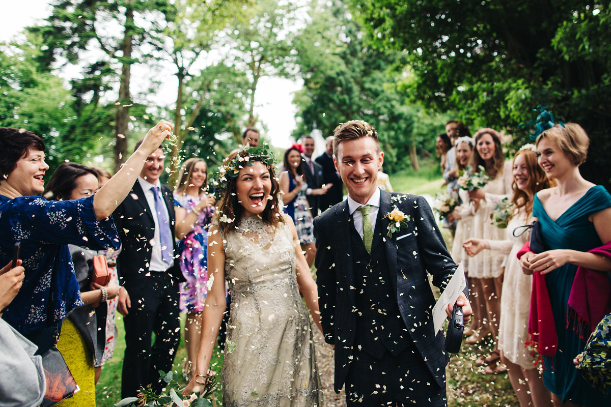 Boho bride Alice wore a pale green lace wedding dress and floral crown for her wild woodland inspired, free spirited South Devon wedding at Langdon Court. Photography by Richard Skins.