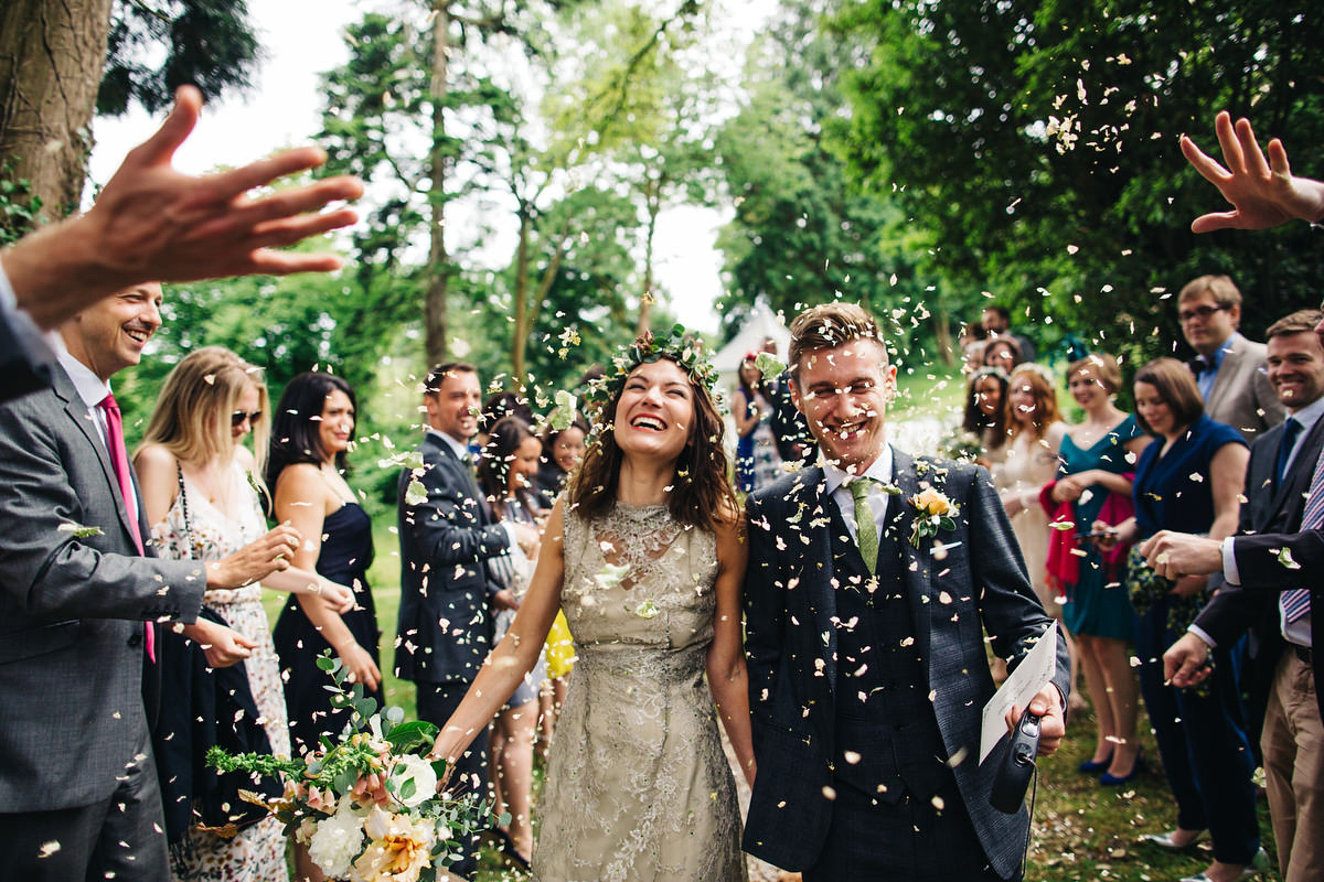 Boho bride Alice wore a pale green lace wedding dress and floral crown for her wild woodland inspired, free spirited South Devon wedding at Langdon Court. Photography by Richard Skins.