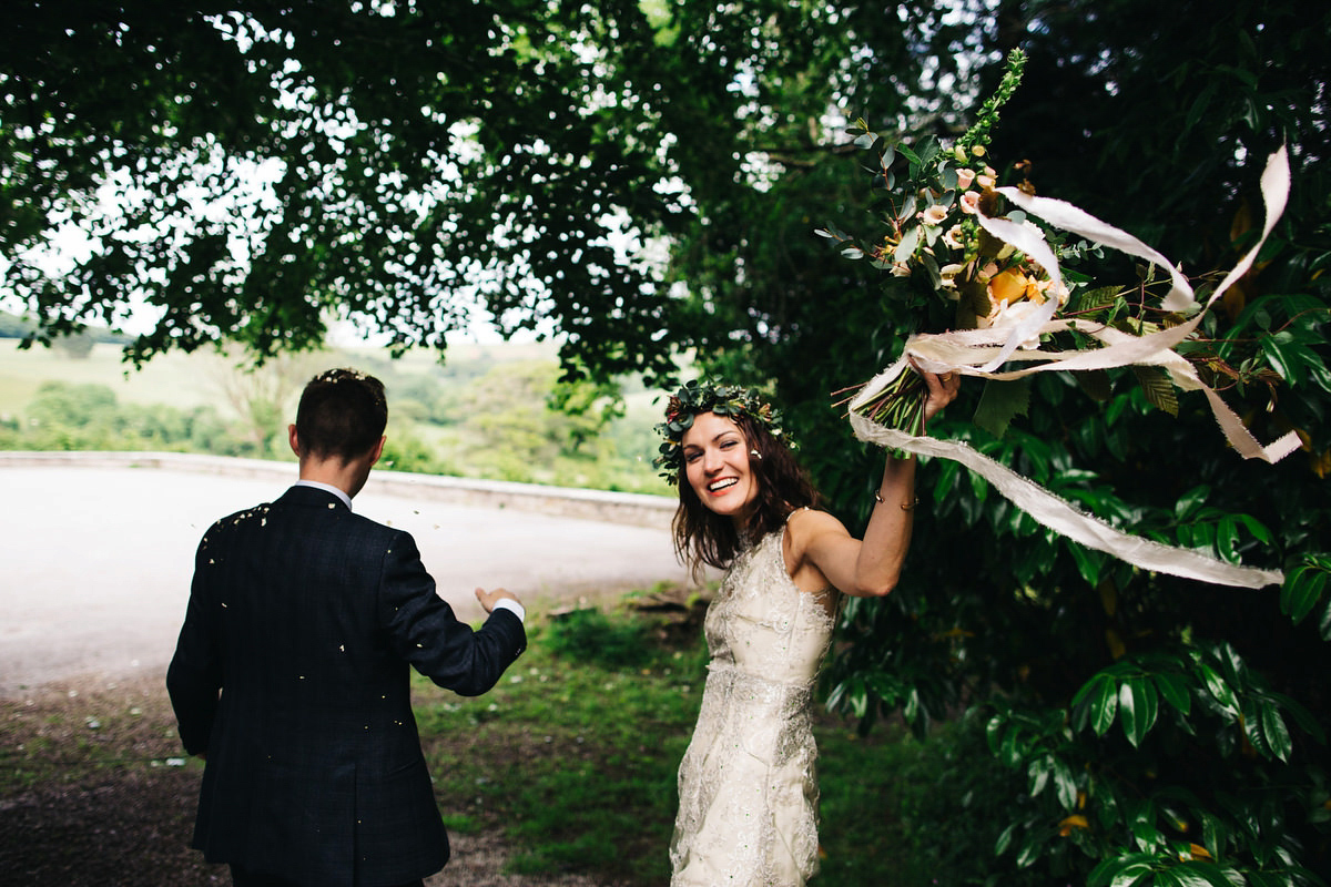 Boho bride Alice wore a pale green lace wedding dress and floral crown for her wild woodland inspired, free spirited South Devon wedding at Langdon Court. Photography by Richard Skins.