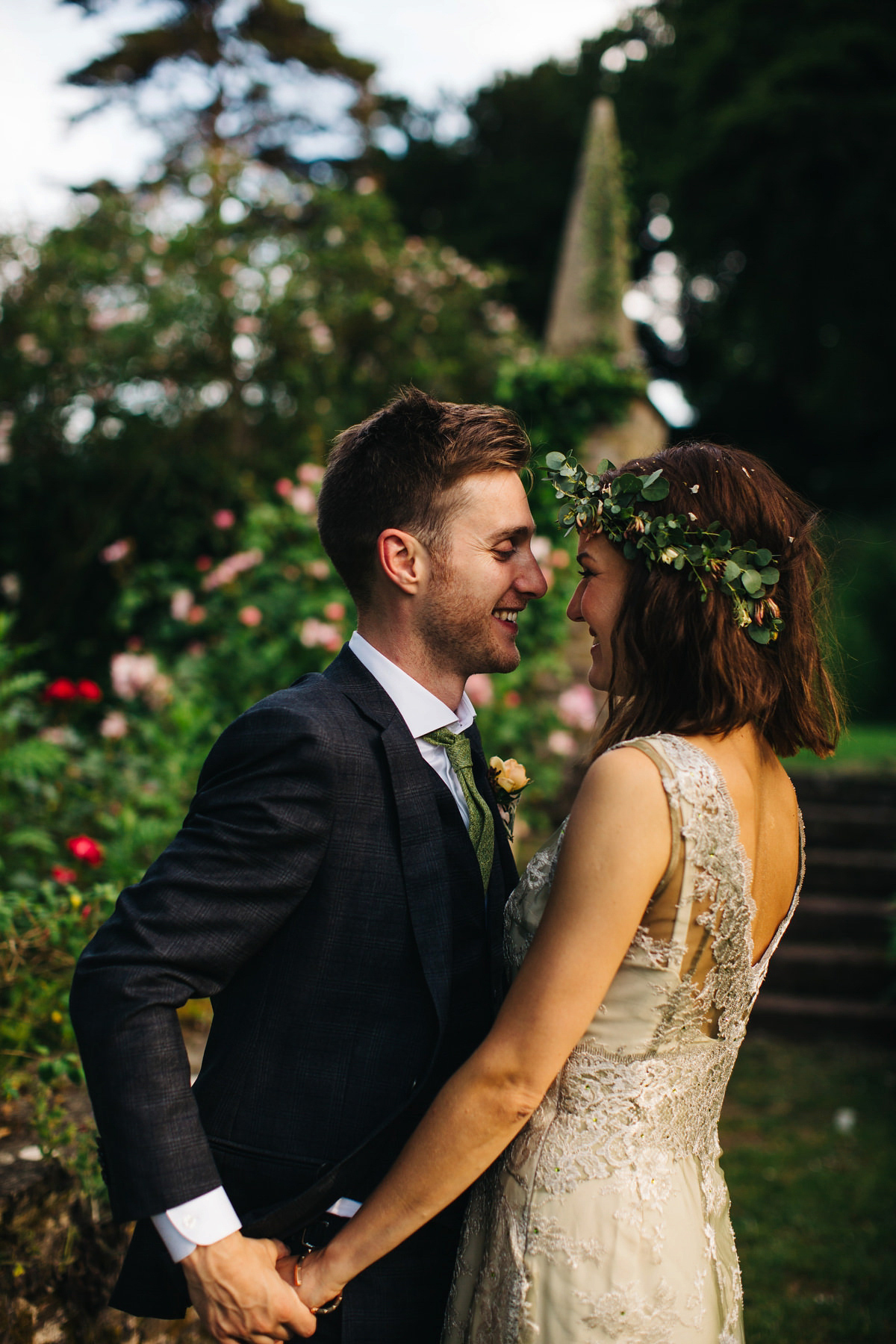 Boho bride Alice wore a pale green lace wedding dress and floral crown for her wild woodland inspired, free spirited South Devon wedding at Langdon Court. Photography by Richard Skins.