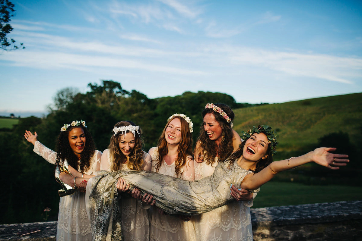 Boho bride Alice wore a pale green lace wedding dress and floral crown for her wild woodland inspired, free spirited South Devon wedding at Langdon Court. Photography by Richard Skins.