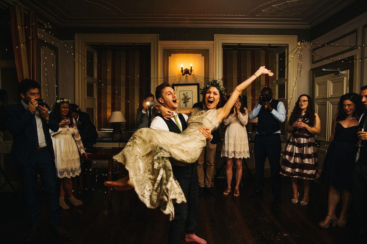 Boho bride Alice wore a pale green lace wedding dress and floral crown for her wild woodland inspired, free spirited South Devon wedding at Langdon Court. Photography by Richard Skins.