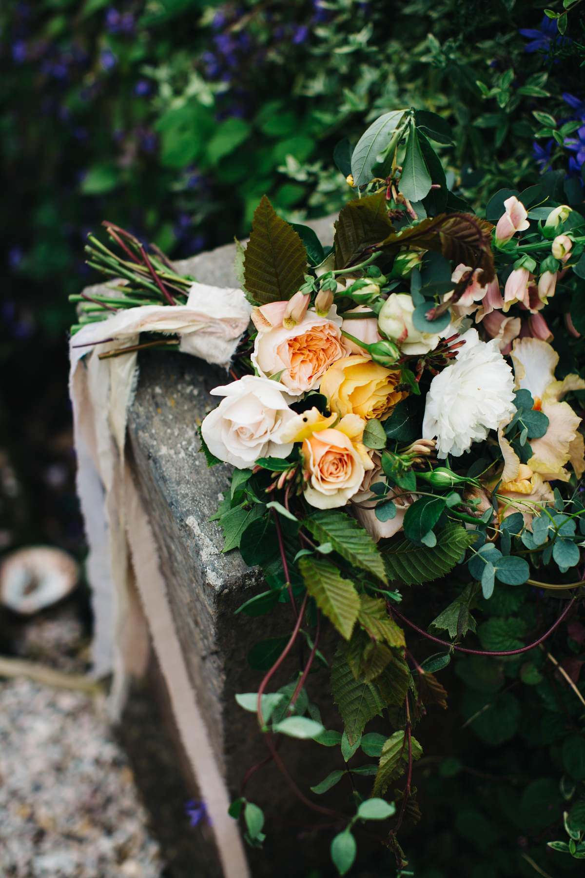 Boho bride Alice wore a pale green lace wedding dress and floral crown for her wild woodland inspired, free spirited South Devon wedding at Langdon Court. Photography by Richard Skins.