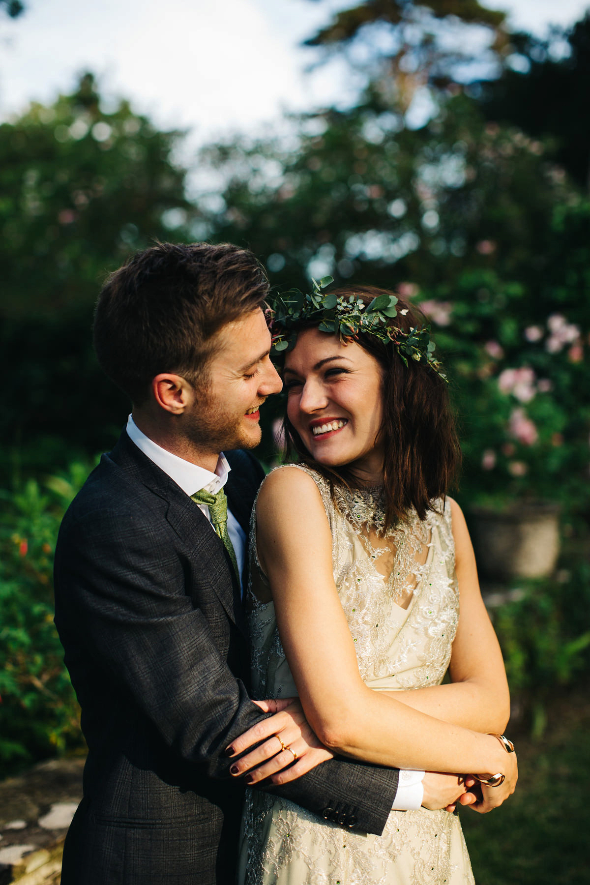 Boho bride Alice wore a pale green lace wedding dress and floral crown for her wild woodland inspired, free spirited South Devon wedding at Langdon Court. Photography by Richard Skins.