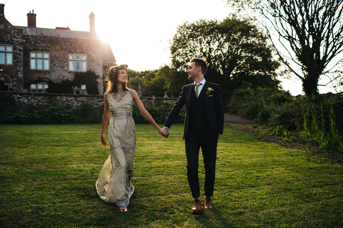 Boho bride Alice wore a pale green lace wedding dress and floral crown for her wild woodland inspired, free spirited South Devon wedding at Langdon Court. Photography by Richard Skins.